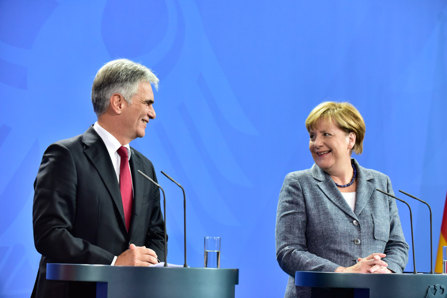 Merkel and Faymann, chatting like old friends.  He actually used the informal, Du, and called her Angela! 
