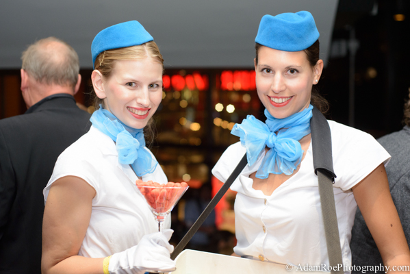 Pan Am flight attendants handing out candy in a martini glass