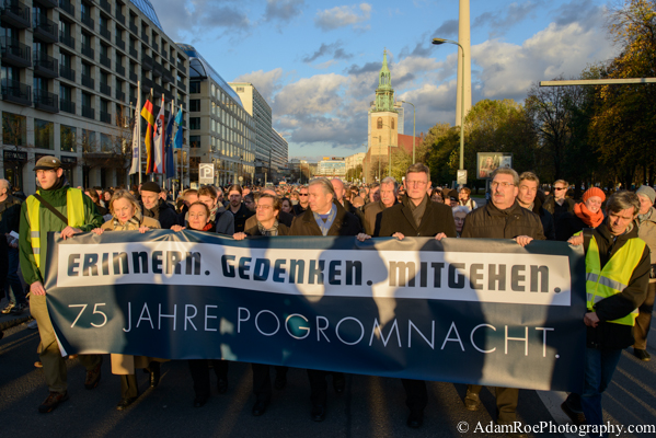"Remeber. Commemorate. March." reads the banner held by the Mayor, Protestant Bishop and Catholic Archbishop of Berlin along with other leaders.
