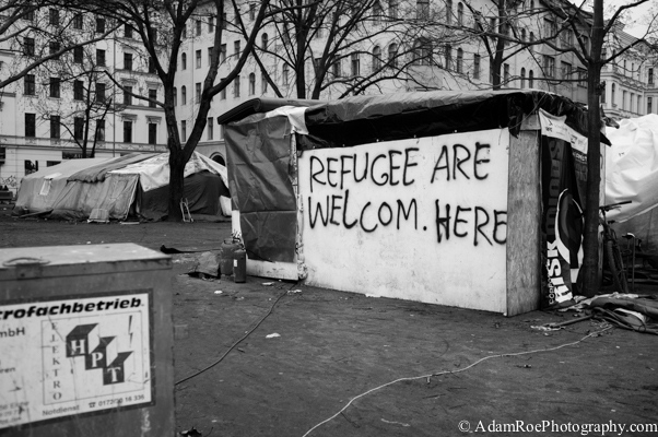 The spray paint on the side of a home at Oranienplatz reads "Refugee are Welcom Here"