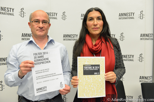 Matthias Polifka and  Selmin Caliskan with the campagin information and 2014 report on torture. 