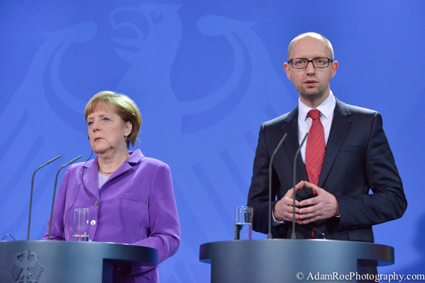 Angela Merkel and Arseniy Yatsenyuk. She listens while he mimics her famous hands.