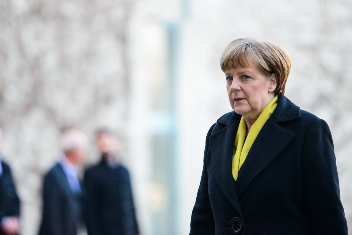 Angela Merkel strolls through the yard at the chancellery.