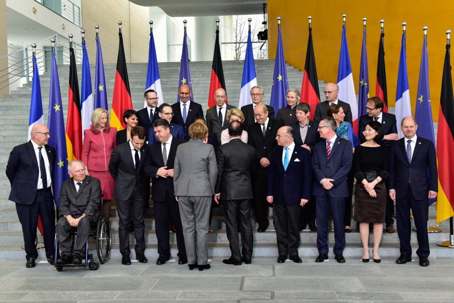 First Row (left to right): Michel Sapin, Wolfgang Schäuble, Emmanuel Macron, Sigmar Gabriel, Angela Merkel and Francois Hollande (backs to camera), Bernard Cazeneuve, Thomas de Maiziere, Fleur Pellerin, Olaf Scholz