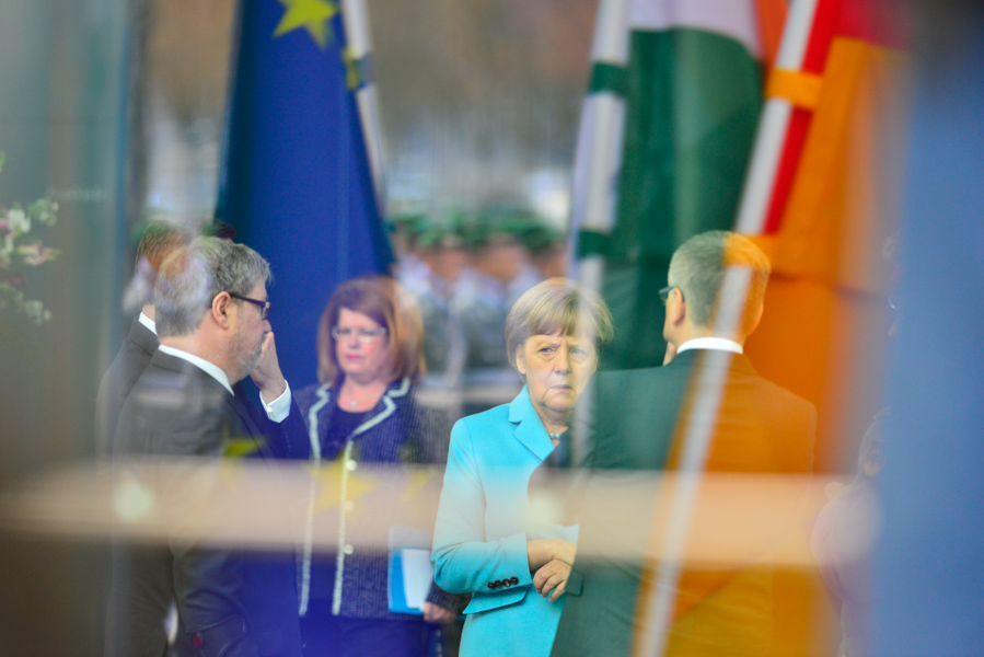 Merkel in the reflections of the Chancellery.